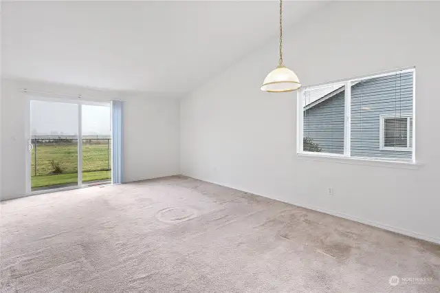 Ample sized living room with dining area and fireplace.