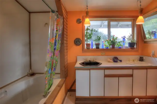 Deep soaker tub in Primary bathroom with double vanity sinks.
