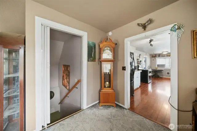 Door to the downstairs, with kitchen to the right.