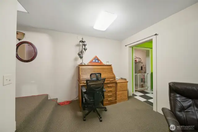 Space at the bottom of the stairs and to the right.
