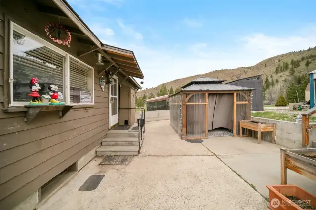 Out the back door and into the pergola that houses the hot tub. Hot tub stays with the home.