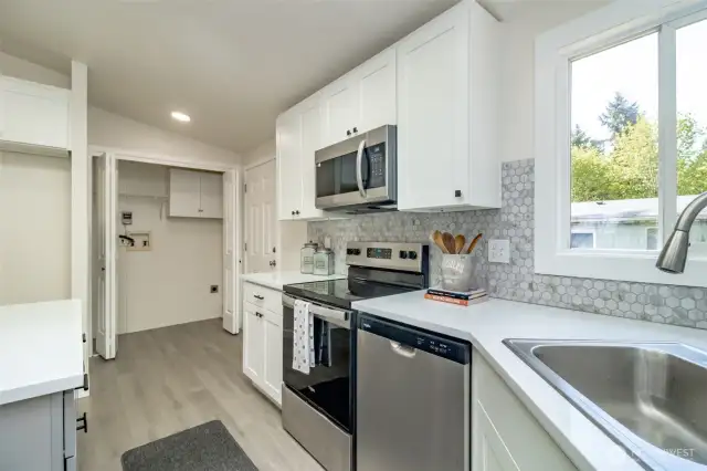 Notice the new stainless steel stove, dishwasher and microwave