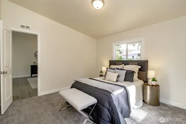 The design of this home creates a private primary suite at the East side of the house and the two additional bedrooms on the West side.