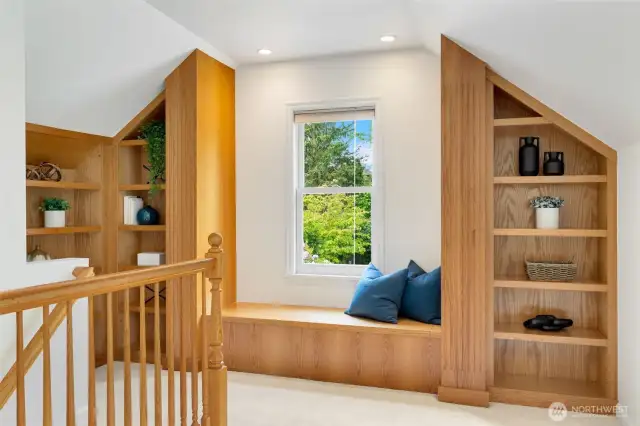 Tasteful oak built-ins and sweet window bench that opens into a storage bin, but is always better as your front row seat to the garden in bloom!