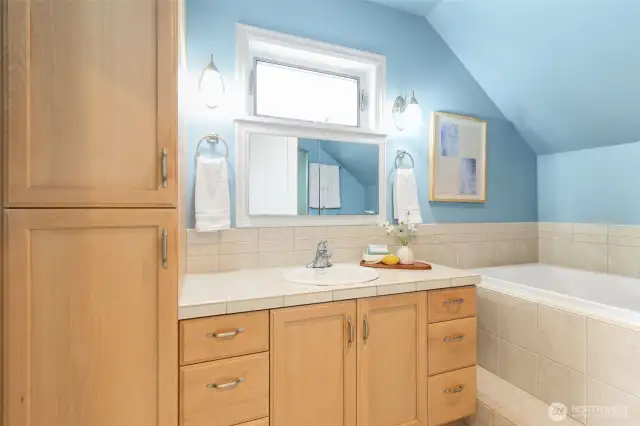 Proper primary bedroom suite with soaking tub and shower.
