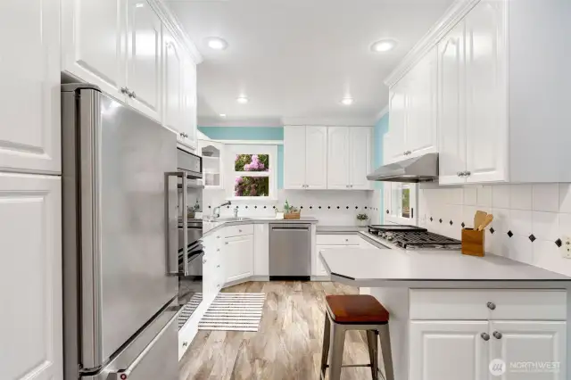 Uplifiting, efficient and inspiring kitchen that leads to back deck.