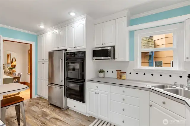 Uplifiting, efficient and inspiring kitchen that leads to back deck.