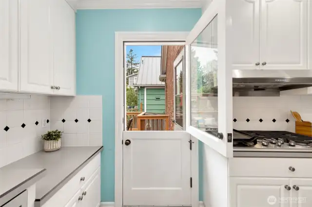 Fanciful doors galore! Dutch door pictured here, pocket doors in the kitchen, and a smart original privacy door to the bedroom hallway.