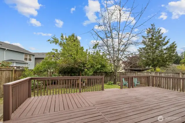 Freshly stained, this spacious deck is the perfect setting for summer gatherings and barbecues.