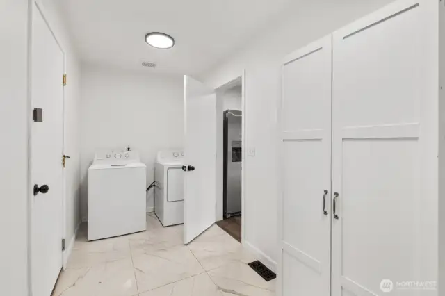 The oversized mud/laundry room, conveniently located off the 2-car garage, serves as an ideal drop zone. Enjoy updated flooring and ample storage in this functional space.