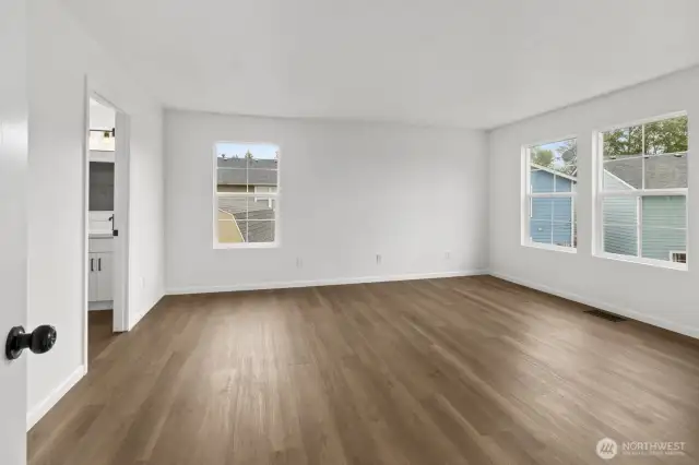 The spacious primary bedroom is bright and cheerful, featuring a generously sized attached bath with updates, along with a large walk-in closet.