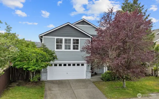 With a 2-car garage, mature landscaping, and excellent curb appeal!