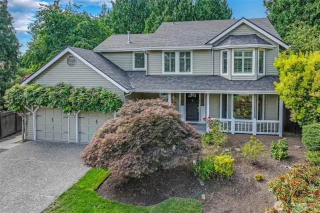 Enjoy a beautifully manicured front yard accented by layered plantings and flowering shrubs. The home’s classic lines, newer roof (2024), and updated windows create a polished look with lasting durability.