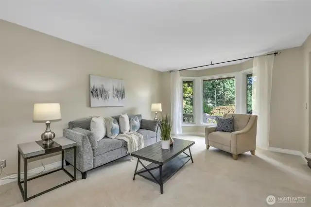 With views to the front yard, the living room features a bay window that allows for natural light and a serene connection to the outdoors. High-quality windows help enhance energy efficiency and year-round comfort.