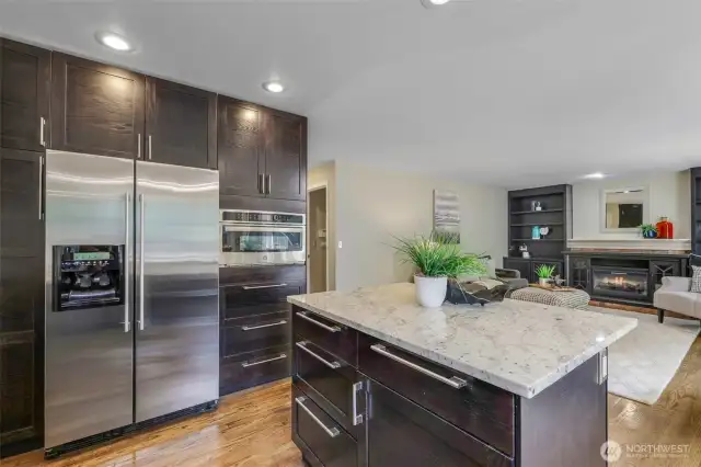 Premium stainless steel appliances and abundant cabinetry offer convenience and style, while the center island provides extra prep space and storage—perfect for daily living and entertaining alike.