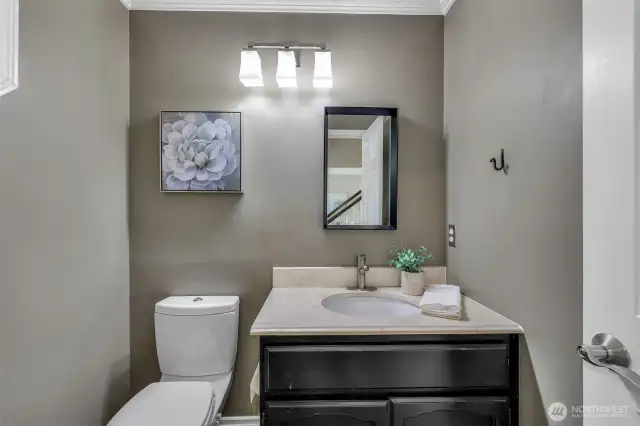The main floor powder bath has been tastefully updated with modern fixtures and cabinetry, providing a stylish and convenient space for guests.