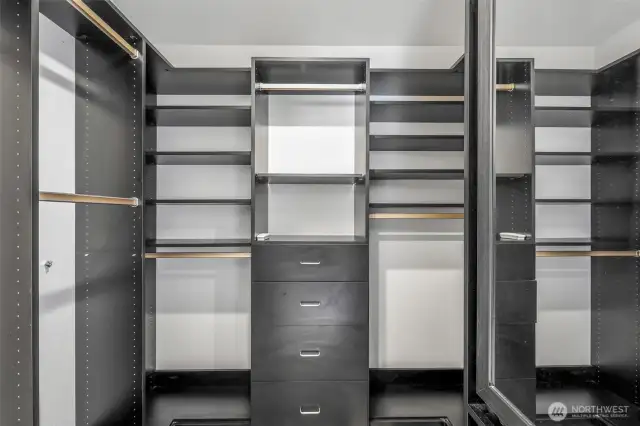 A custom walk-in closet system maximizes storage and organization, with built-in drawers, shelves, and hanging space designed to keep everything in its place.