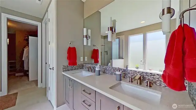 Primary bathroom with dual vanity and large walk-in closet