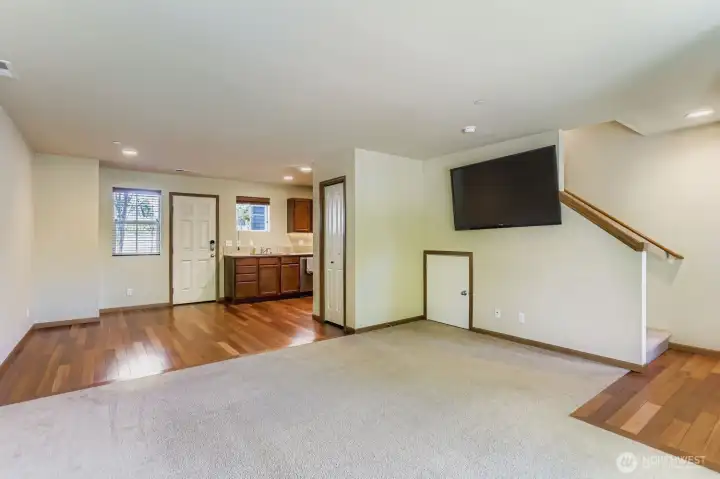 Another angle of the living room open to the dining room which is open to kitchen.
