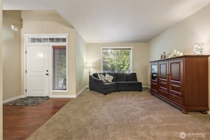 Open, vaulted ceiling entry with living room open to dining room