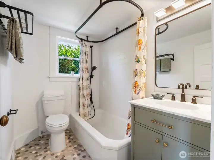 The newly remodeled full bath on the main floor is gorgeous with old fashion chsrm. Updated plumbing g.