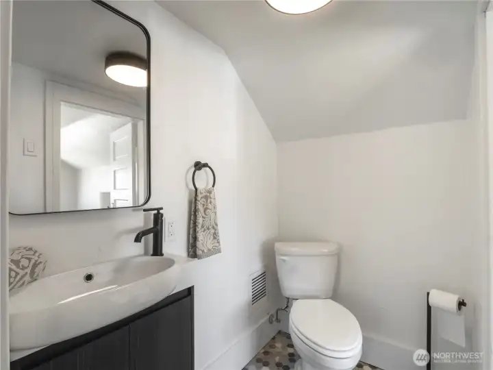 A cute half bath was added ti the top floor.