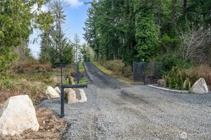 Your new estate welcomes you in via a new steel privacy gate! The luxurious entry implies the elegance to be found throughout this amazing property and home. Feels so very private and rural, yet shopping and town are mere minutes away.