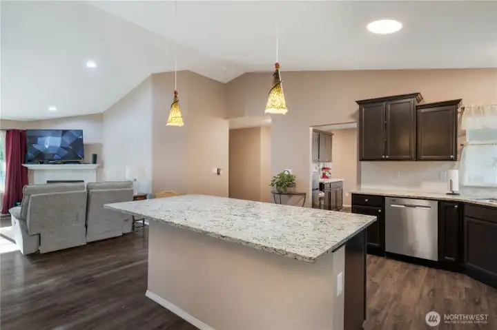 Upon entering, you are greeted by the spacious and open floor plan offering expansive living spaces, a welcoming great-room feel, the gleaming kitchen, and access to the big covered deck overlooking the private backyard portion of the acreage. If you love to cook, you'll adore the gas (propane) cooktop, and the fireplace provides an inviting area to relax.