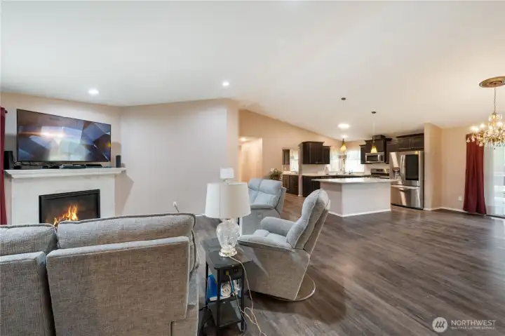 Soaring vaulted ceilings add to the 'wow' factor when you enter this delightful home. The luxury vinyl plank floors through much of the home are perfect for a home on acreage, with so much to enjoy and explore in the outside. They're both elegant and bulletproof when outdoor life sneaks in on someone's shoes!