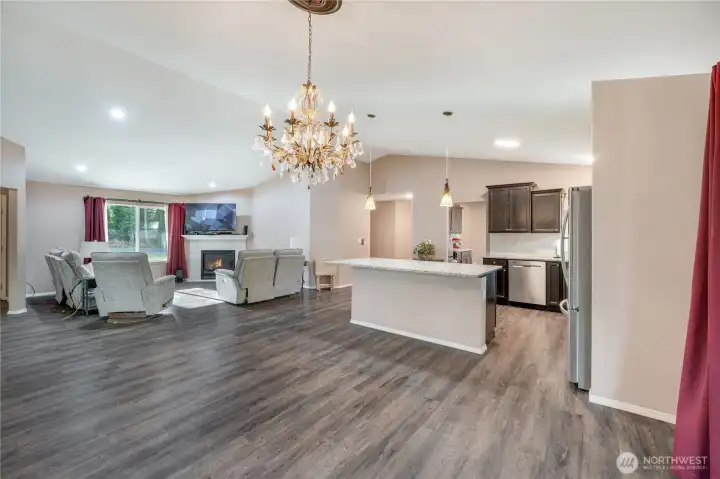 The entryway in the center of the photo leads to the utility room (the apartment can have its own laundry) the garage, studio space and to the primary suite.