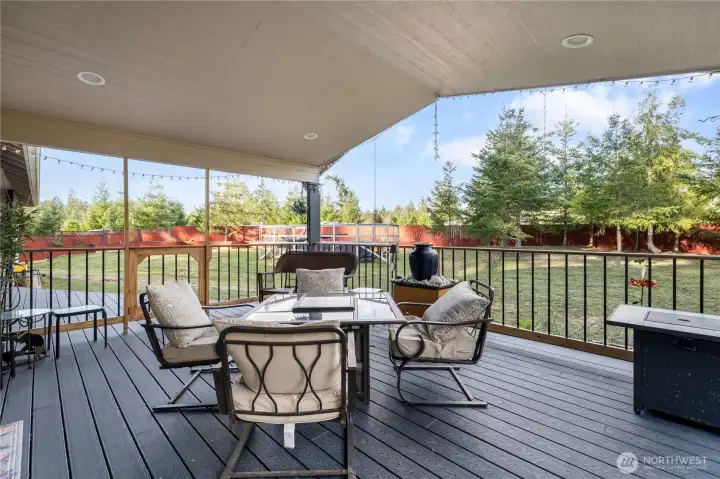 What a paradise inside and out! Here's a delightful place to relax with a cup of coffee or your favorite beverage and feel the breeze and listen to the sounds of nature. And a bit of rain will never faze you under cover on this spacious deck. Fire up the grill year-round!