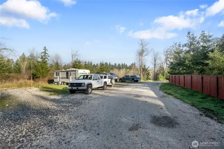 Your new estate includes the land inside the fence on the right, and the property you see to the left of it. Outside the fenced private backyard is the gravel access to the RV spaces and laundry building (not shown) which the sellers put in for visitors. They considered renting these out, but didn't pursue permits as they were moving. Utilities and even a holding tank is in place. How will you utilize all this developed space?