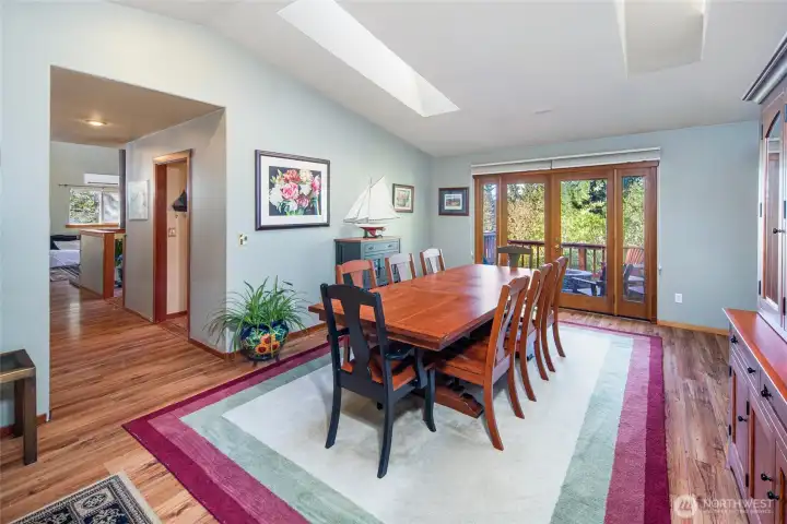 Formal dining room with skylight, French doors to the deck, and generous space for hosting gatherings both large and small.