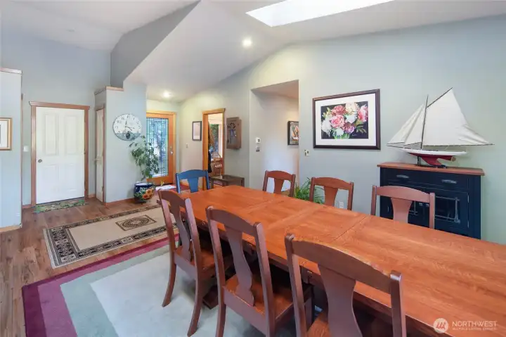 Light-filled dining area offers seamless indoor-outdoor living with direct access to the deck and peaceful views of the surrounding trees.