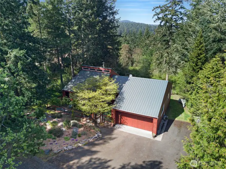 Privately tucked among towering trees, this well-maintained rambler offers peaceful island living on a beautifully wooded .76-acre parcel near town.