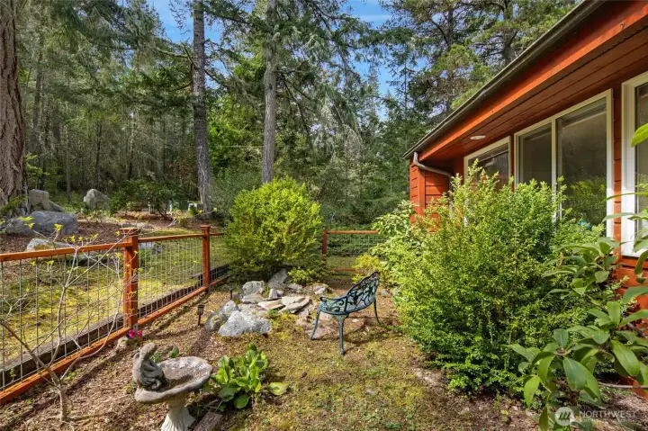 Warm cedar exterior  surrounded by lush Northwest landscaping.