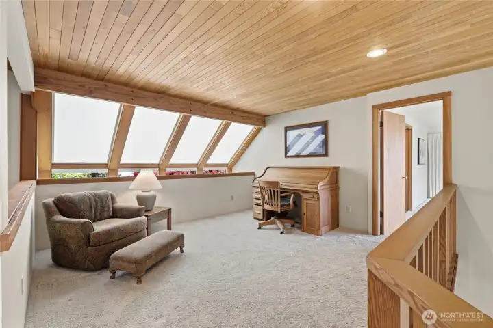 Bright loft-style space with wood ceilings and flexible room for a lounge or office. Bright loft-style space with wood ceilings and flexible room for a lounge or office.