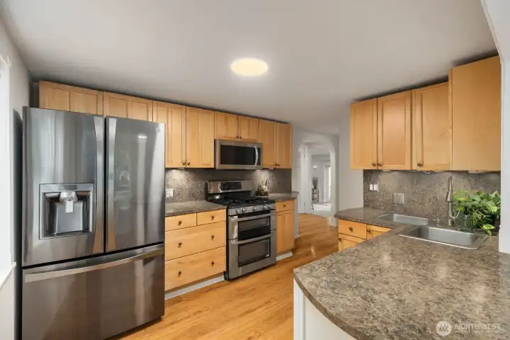 Spacious refreshed kitchen with abundant counter space and hardwood floors