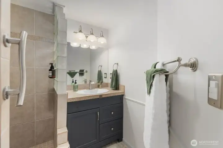 Spa inspired, refreshed full bath with updated finishes, and designer tile work.