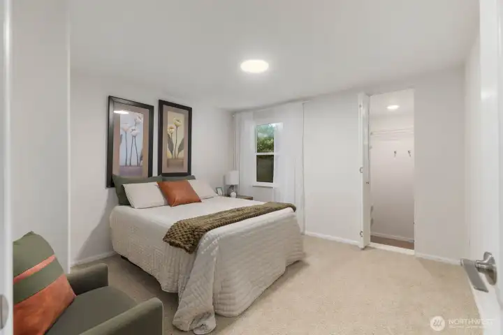 Comfortable oversized bedroom with walk-in closet and soft natural light