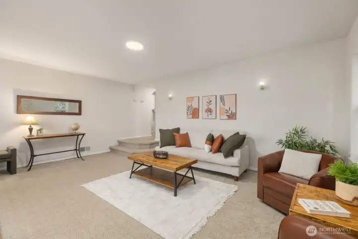 Spacious refreshed, living area with soft, lighting and comfortable gathering spaces