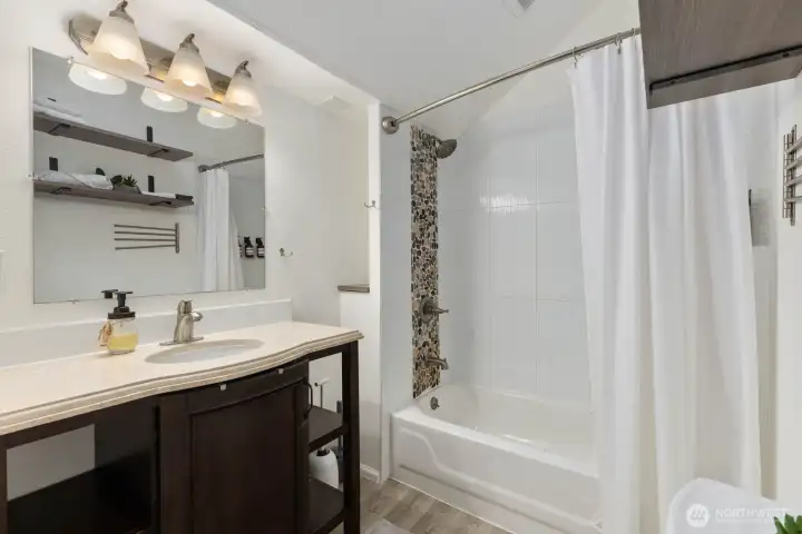 Bright full bath in the ADU, with updated finishes, tile accents, and abundant storage