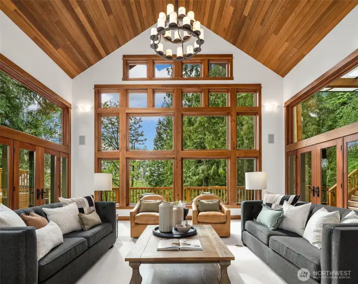 The great room with simply stunning views & 25' tall ceilings.