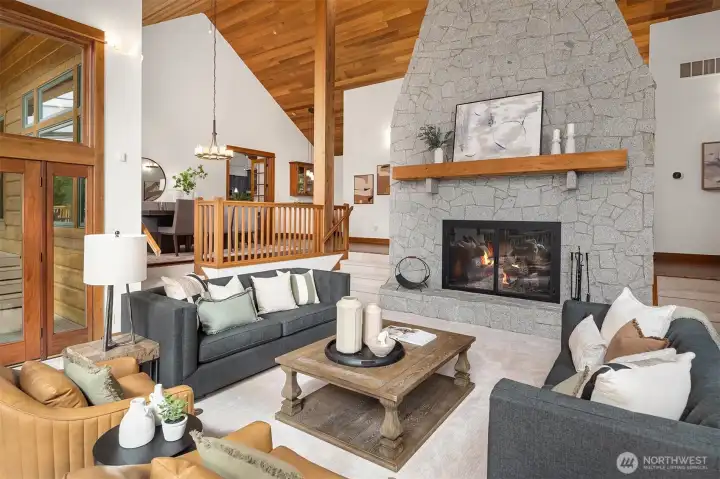 Offering 3 fireplaces-one with a dynamic floor to ceiling live edge granite surround.