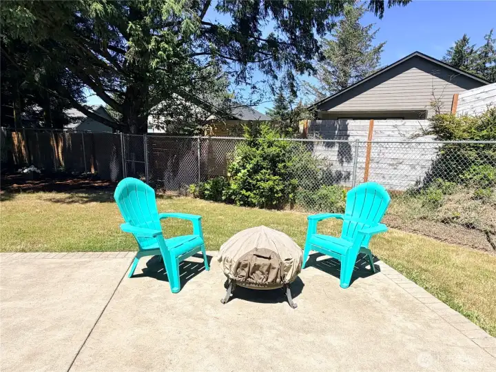 Relax on the patio and enjoy the spacious backyard.