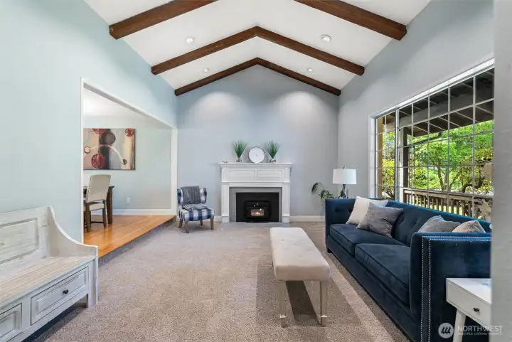 Cathedral ceilings with exposed beams are the true highlight of this formal living room with a wall of windows looking to your lush green yard. Cathedral ceilings with exposed beams are the true highlight of this formal living room with a wall of windows looking to your lush green yard.