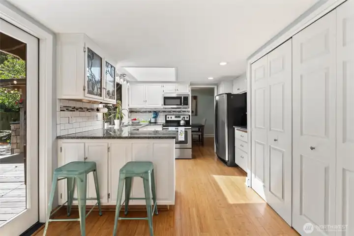 Enjoy white painted cabinets, stained glass fronts, and views to the incredible park-like backyard in this kitchen! Enjoy white painted cabinets, stained glass fronts, and views to the incredible park-like backyard in this kitchen!