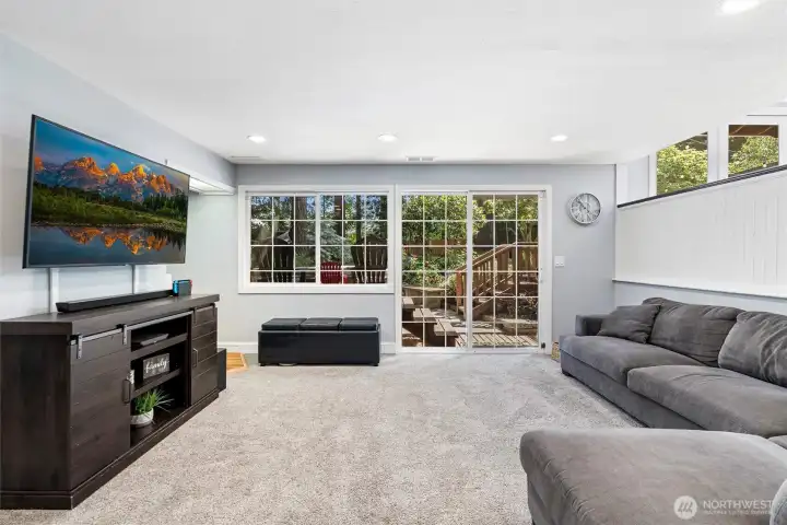 Lower level living room with slider to the backyard and hot tub. Lower level living room with slider to the backyard and hot tub.
