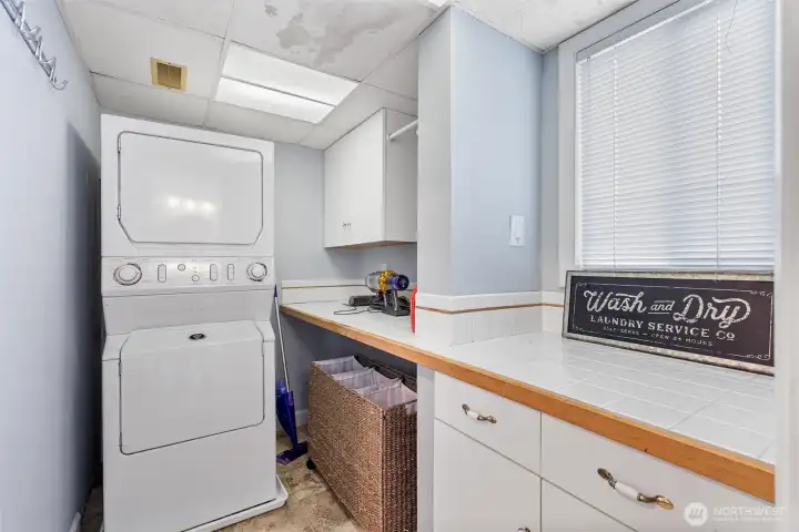 Enjoy a large laundry room with storage and counter space for easy folding and organizing. Enjoy a large laundry room with storage and counter space for easy folding and organizing.
