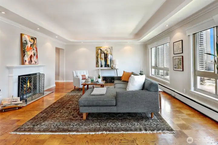 The living room features high ceilings & recessed lighting
